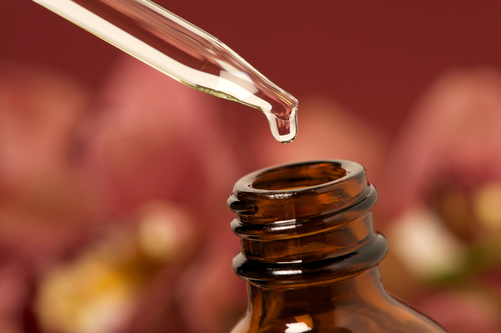 Essential oils with dropper above bottle